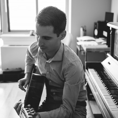 Playing Guitar at Piano - Black & White